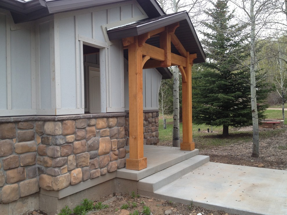 This is an example of a medium sized rustic front veranda in Salt Lake City with a roof extension.