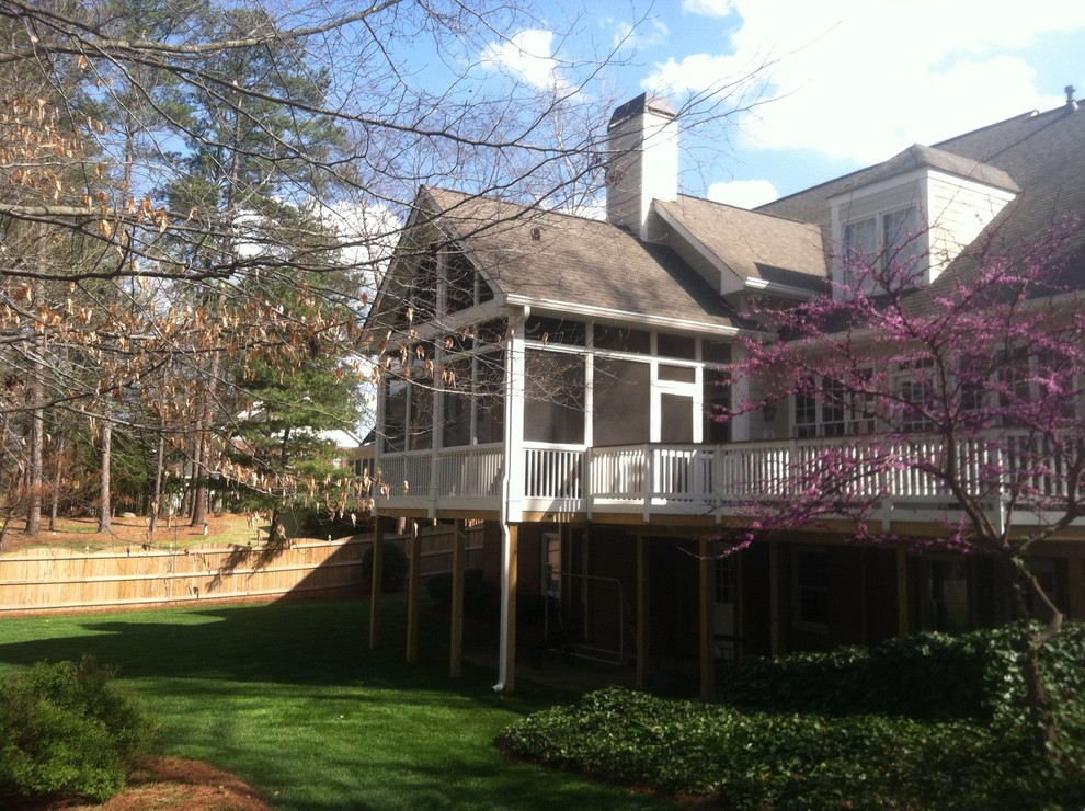 Design ideas for a medium sized traditional back screened veranda in Atlanta with decking and a roof extension.