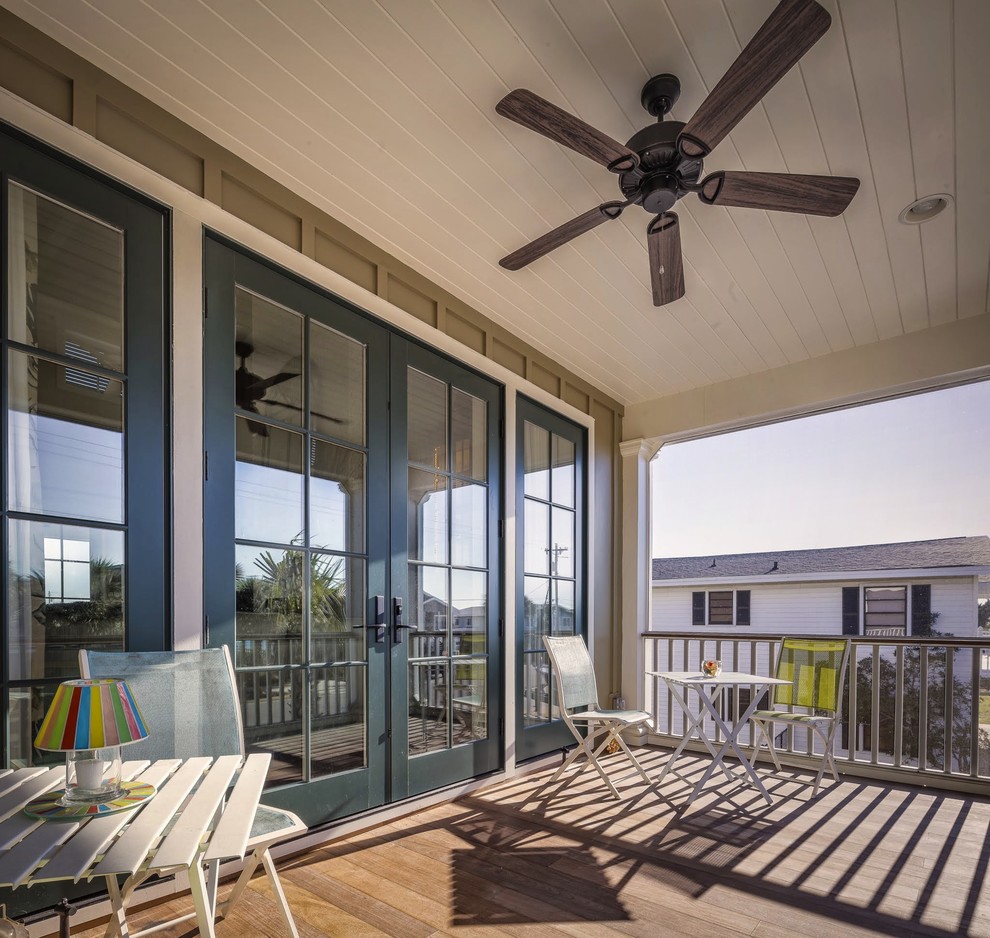 This is an example of a medium sized beach style back veranda in Charleston.
