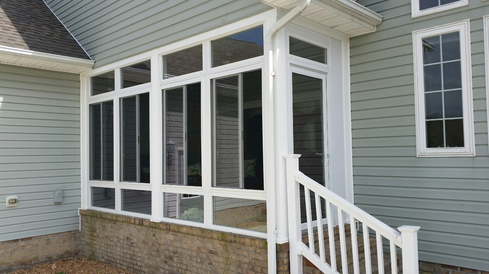 Photo of a medium sized traditional side veranda in Other with brick paving and a roof extension.