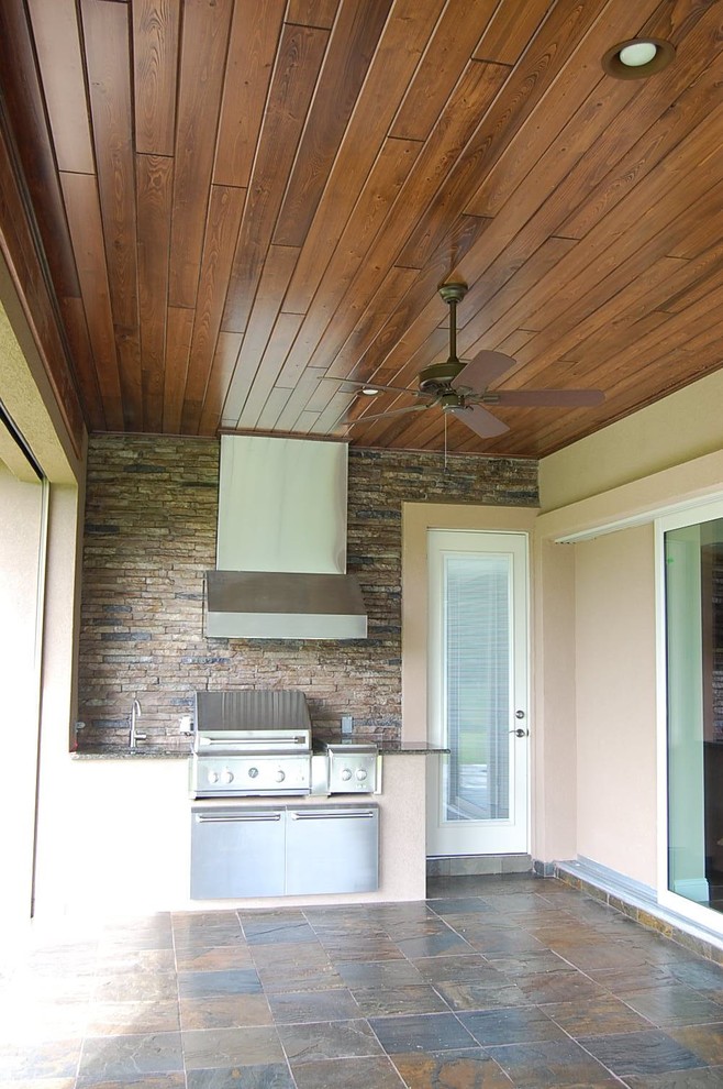 Inspiration for a large contemporary back veranda in Jacksonville with an outdoor kitchen, tiled flooring and a roof extension.