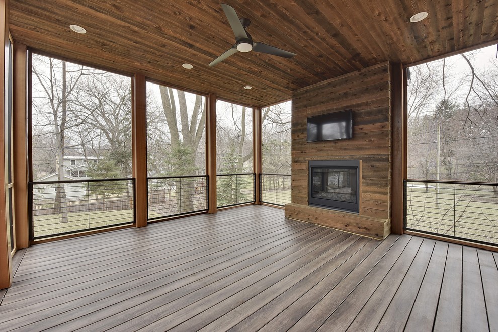 Cette image montre un grand porche d'entrée de maison minimaliste avec une cheminée.