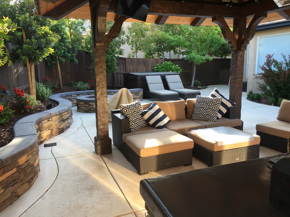 Patio - mid-sized traditional backyard concrete paver patio idea in Sacramento with a pergola