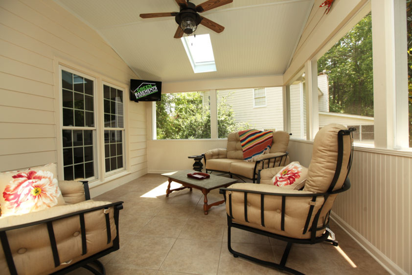 Medium sized contemporary back screened veranda in Atlanta with tiled flooring and a roof extension.