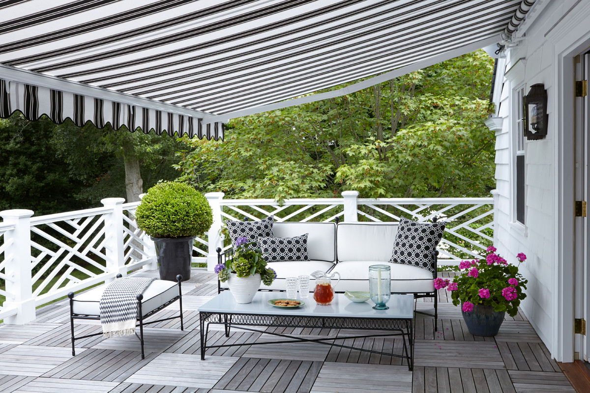 This is an example of a traditional porch design in New York with decking and an awning.