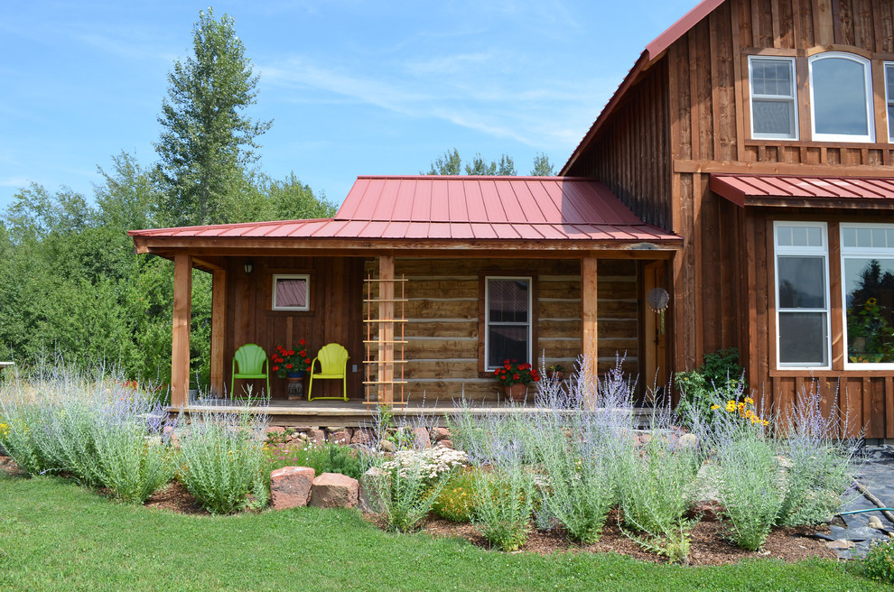 Mountain style porch idea in Boise with decking and a roof extension
