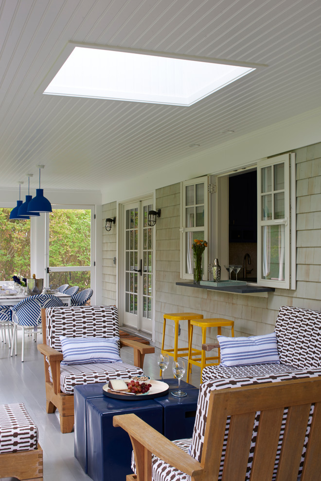 Cette image montre un porche d'entrée de maison arrière marin de taille moyenne avec une terrasse en bois et une extension de toiture.
