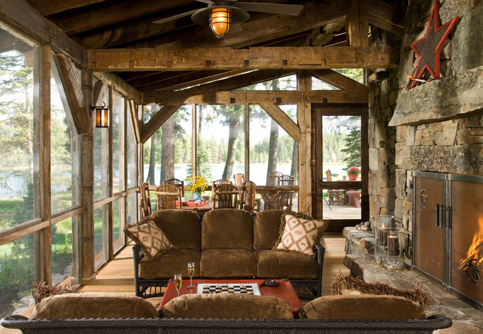 Cette image montre un porche d'entrée de maison chalet avec une moustiquaire, une terrasse en bois, une extension de toiture et tous types de couvertures.