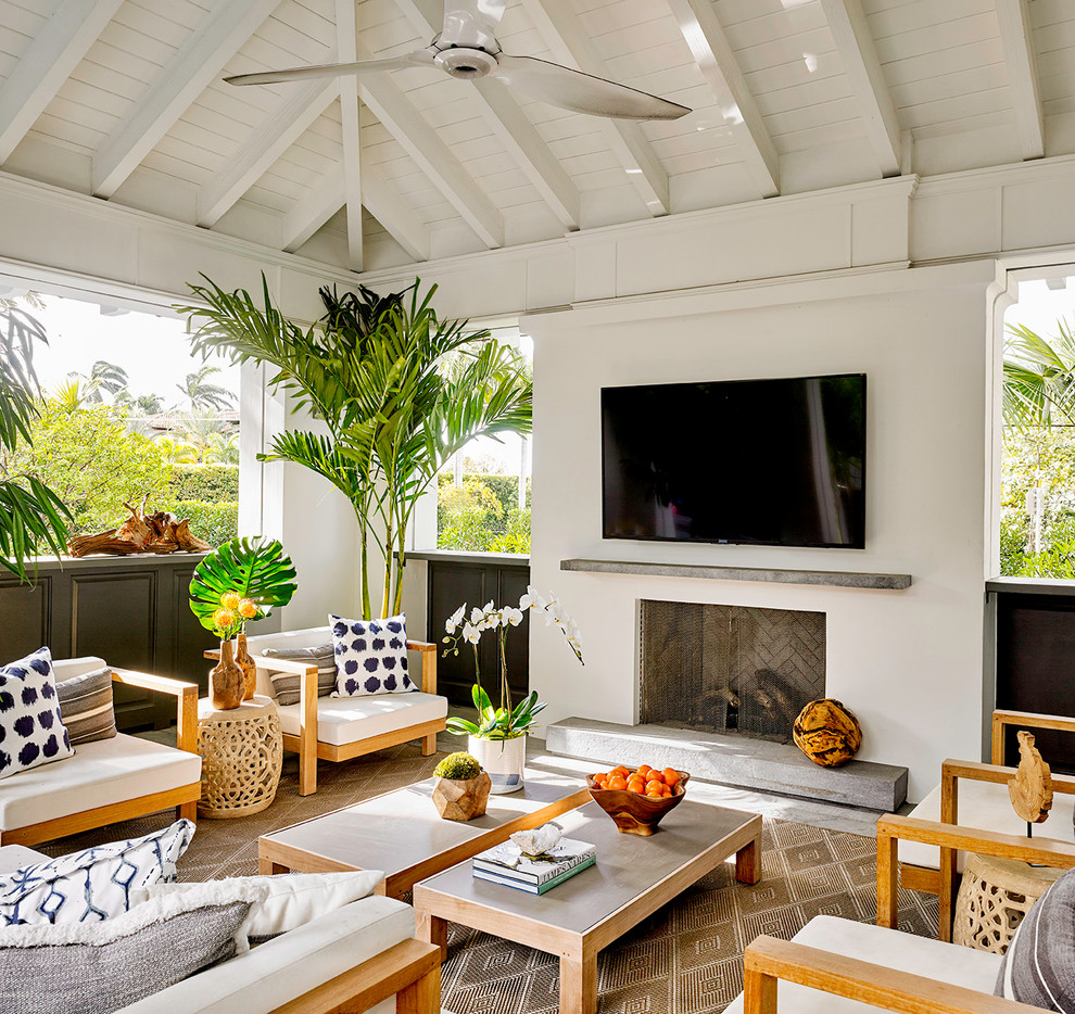 Inspiration for a beach style veranda in Miami with a fireplace.