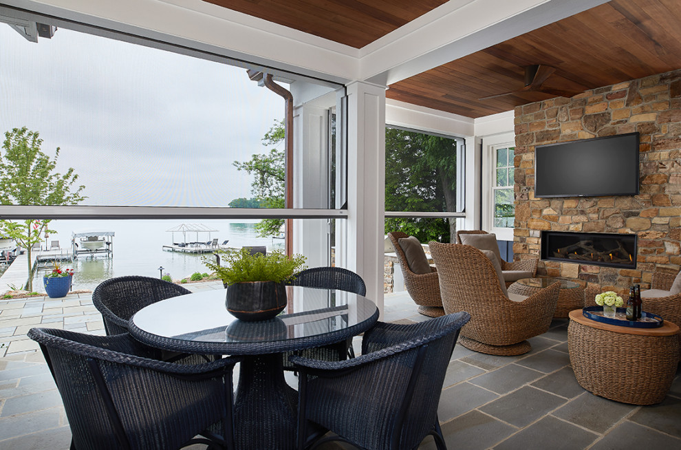 Small beach style stone screened-in back porch photo in Grand Rapids with a roof extension