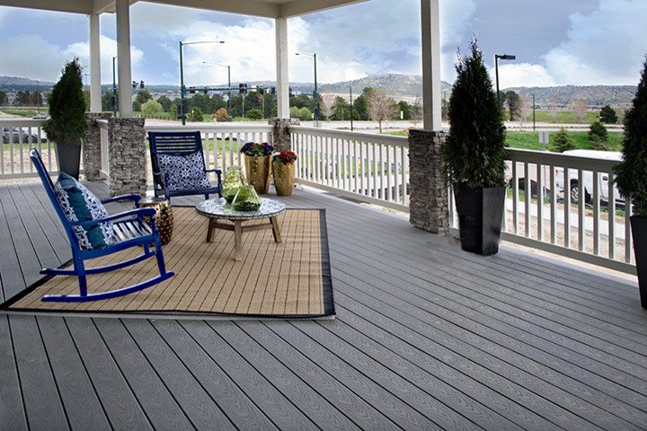 Photo of a large country front veranda in Denver with a roof extension.