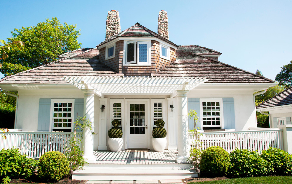 Mid-sized beach style front porch photo in New York with decking and a pergola