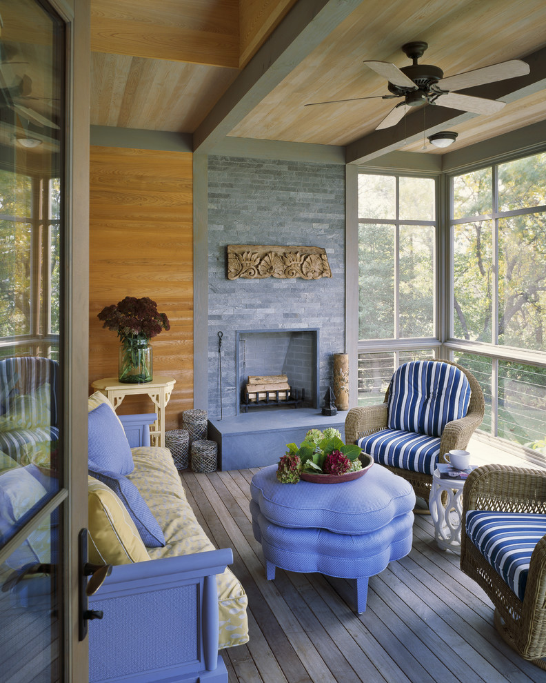 Idées déco pour un porche d'entrée de maison montagne avec un foyer extérieur, une terrasse en bois et une extension de toiture.