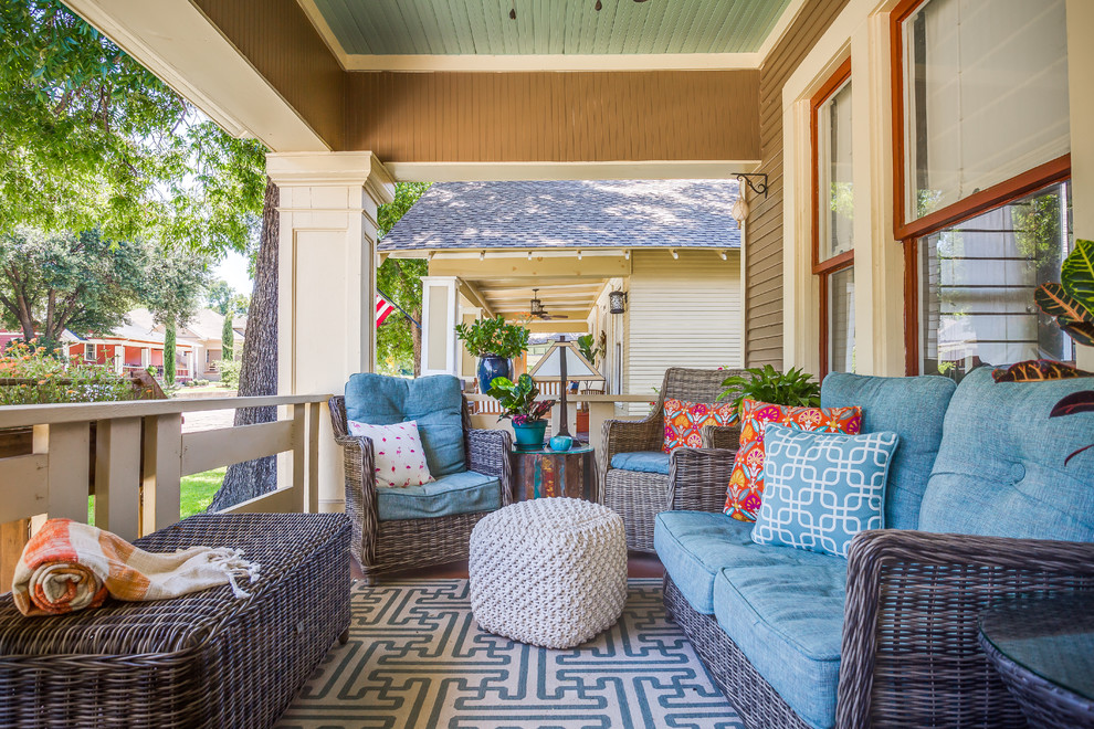 This is an example of a small craftsman front porch design in Dallas with a roof extension and decking.