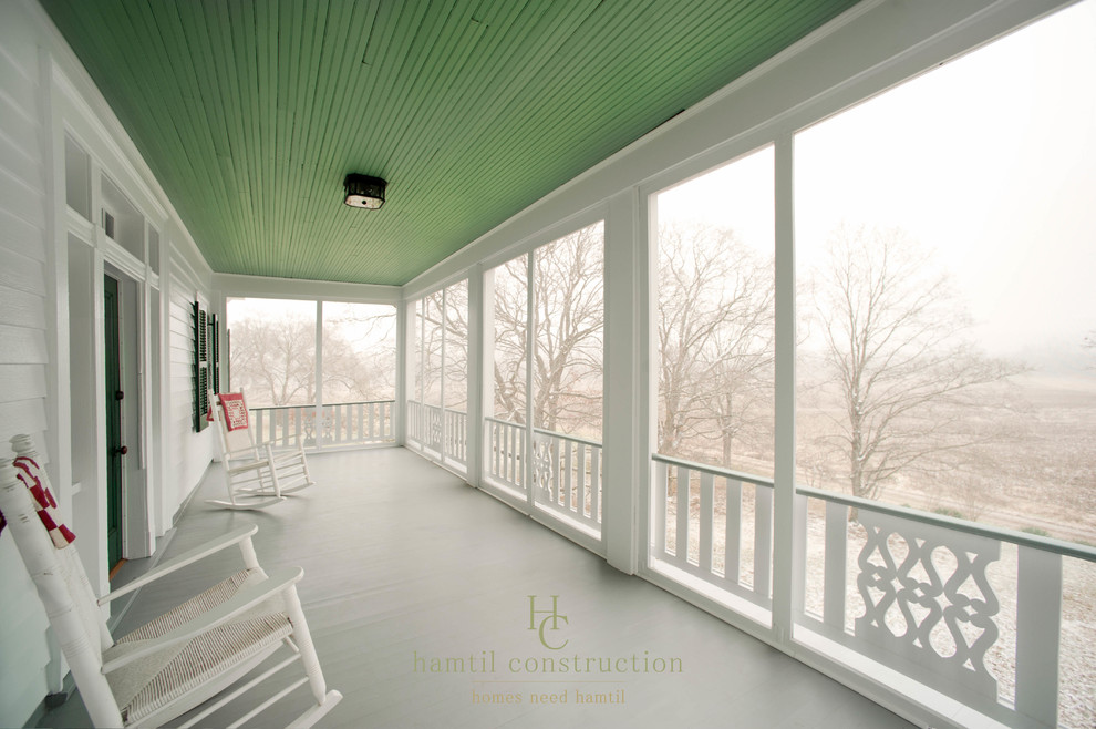 Large country front porch photo in St Louis with a roof extension and decking
