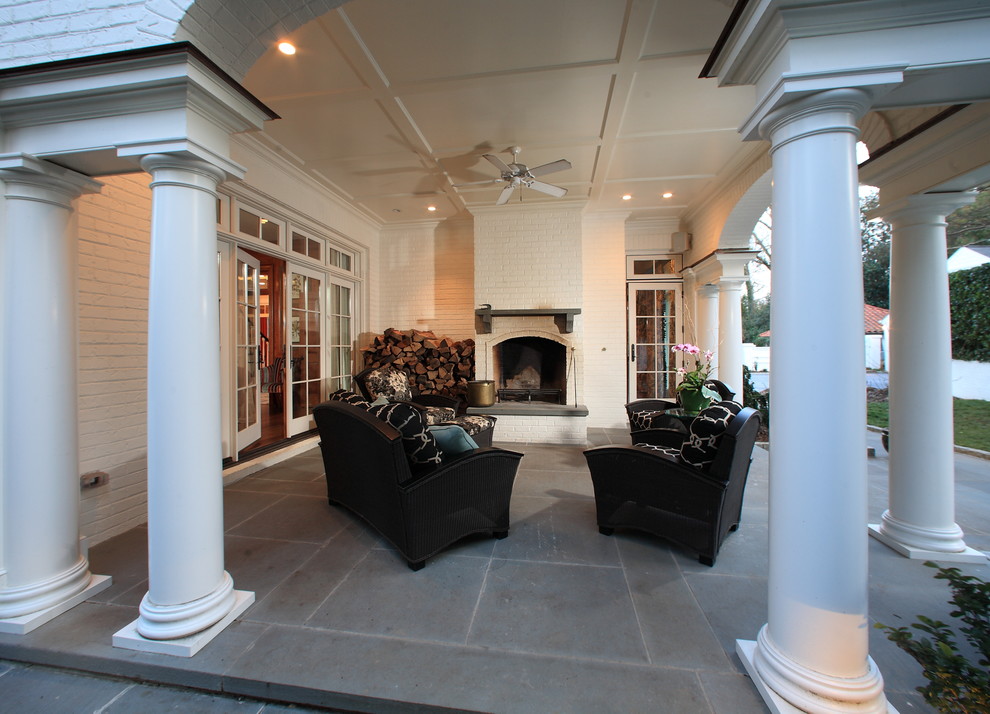 Inspiration for a mid-sized timeless concrete paver back porch remodel in Raleigh with a fire pit and a roof extension