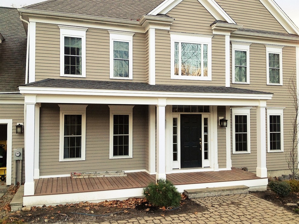 Mid-sized farmhouse front porch photo in Boston with decking and a roof extension