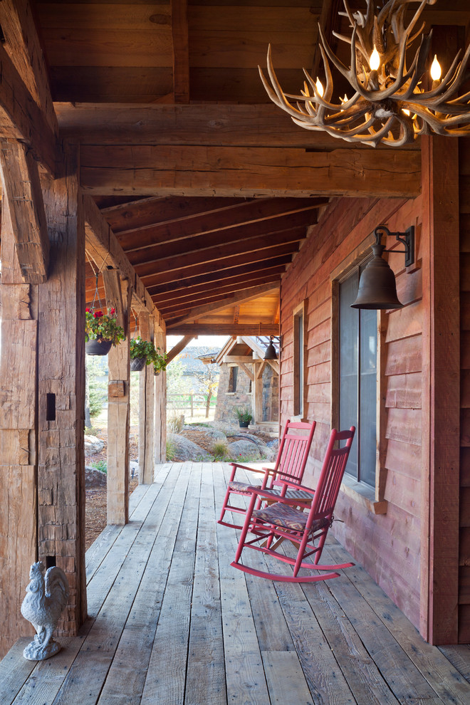 This is an example of a medium sized rustic veranda in Denver with decking and a roof extension.