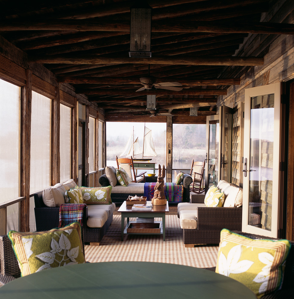 Mountain style screened-in porch idea in DC Metro with a roof extension