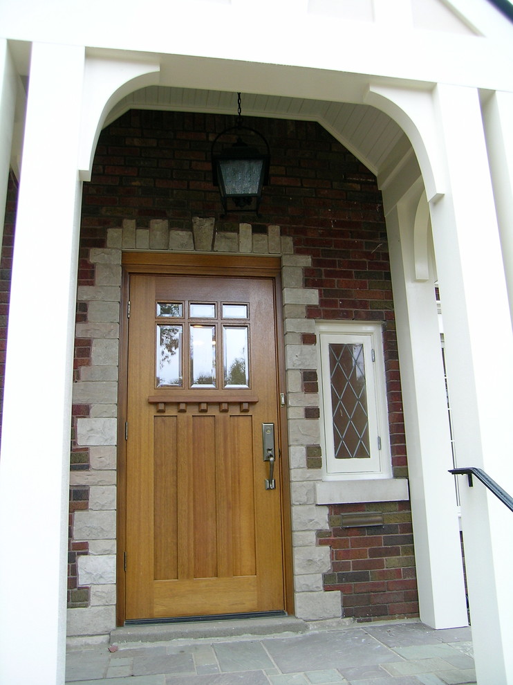 Mid-sized elegant stone front porch photo in Louisville
