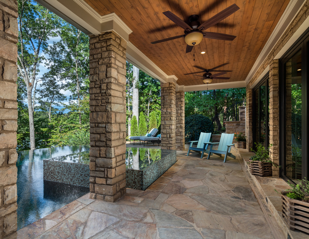 Inspiration for a medium sized classic back veranda in Atlanta with a potted garden, a roof extension and natural stone paving.