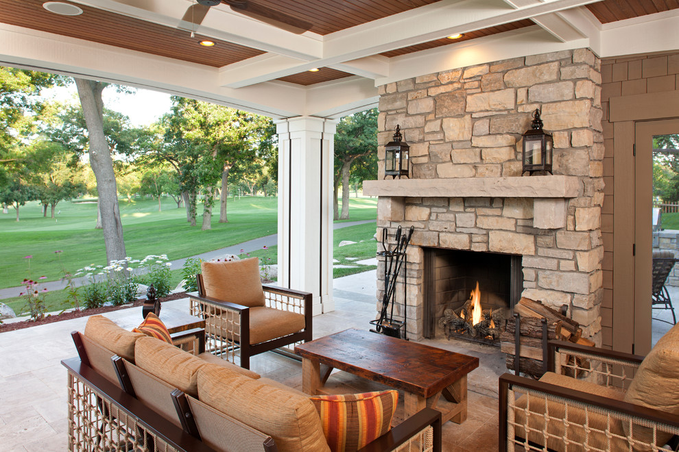 Classic veranda in Minneapolis with a fire feature and a roof extension.