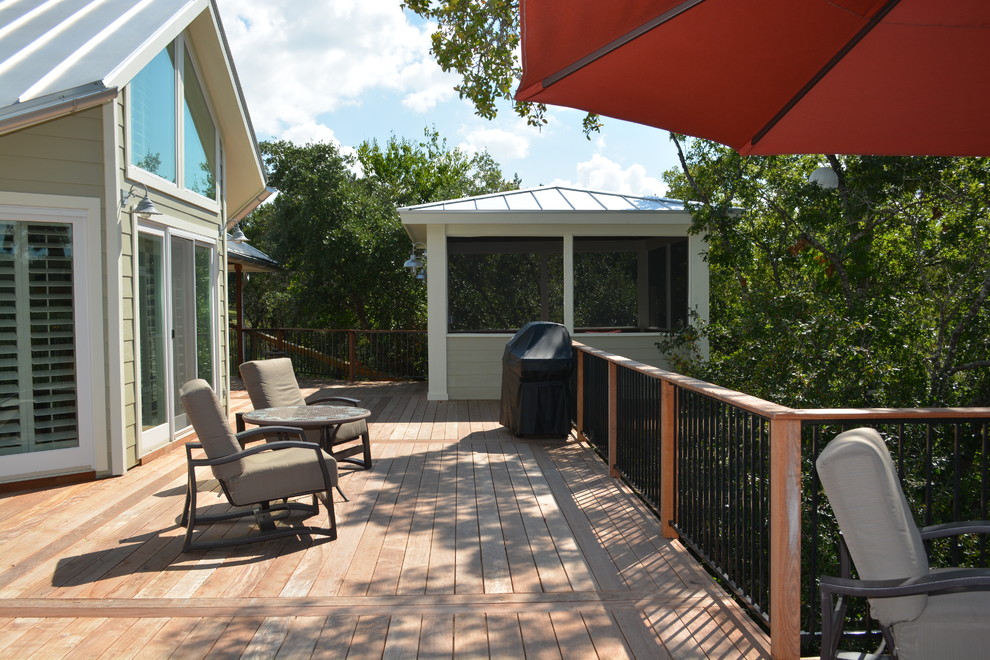 Inspiration for a large classic back veranda in Austin with decking and a roof extension.