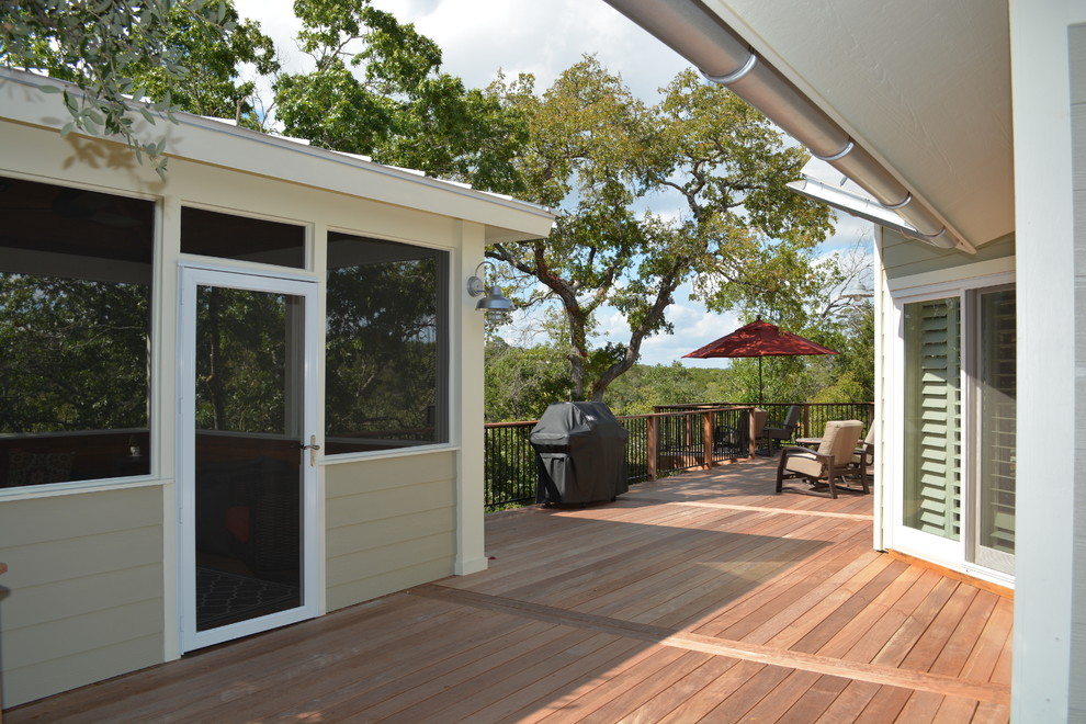 Large classic back porch idea in Austin with decking and a roof extension
