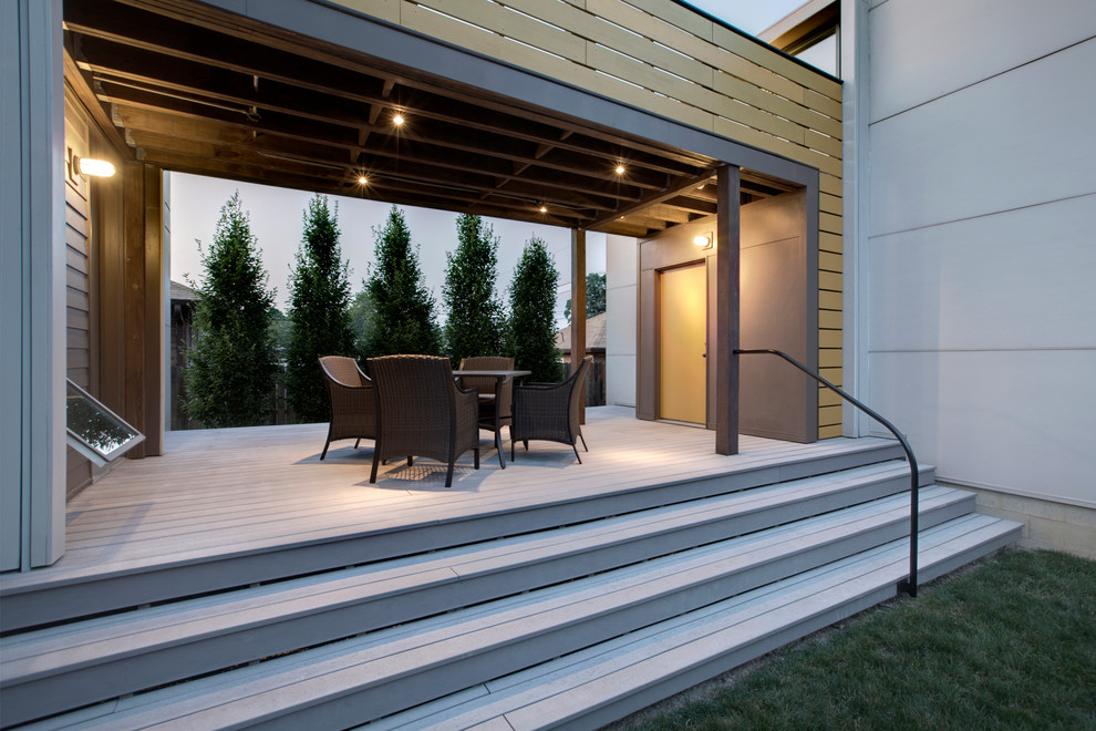 Small minimalist back porch idea in Indianapolis with decking and a roof extension