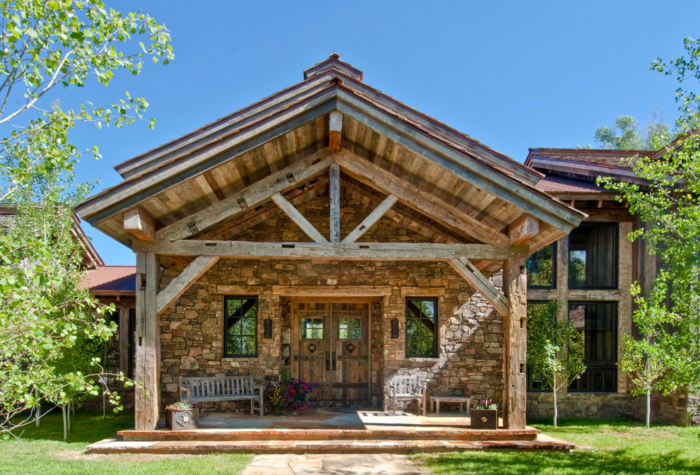 Idées déco pour un porche d'entrée de maison avant montagne avec des pavés en pierre naturelle et une extension de toiture.