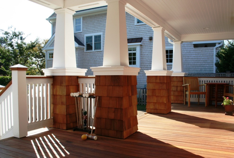 Inspiration for a small nautical front veranda in New York with a roof extension and decking.