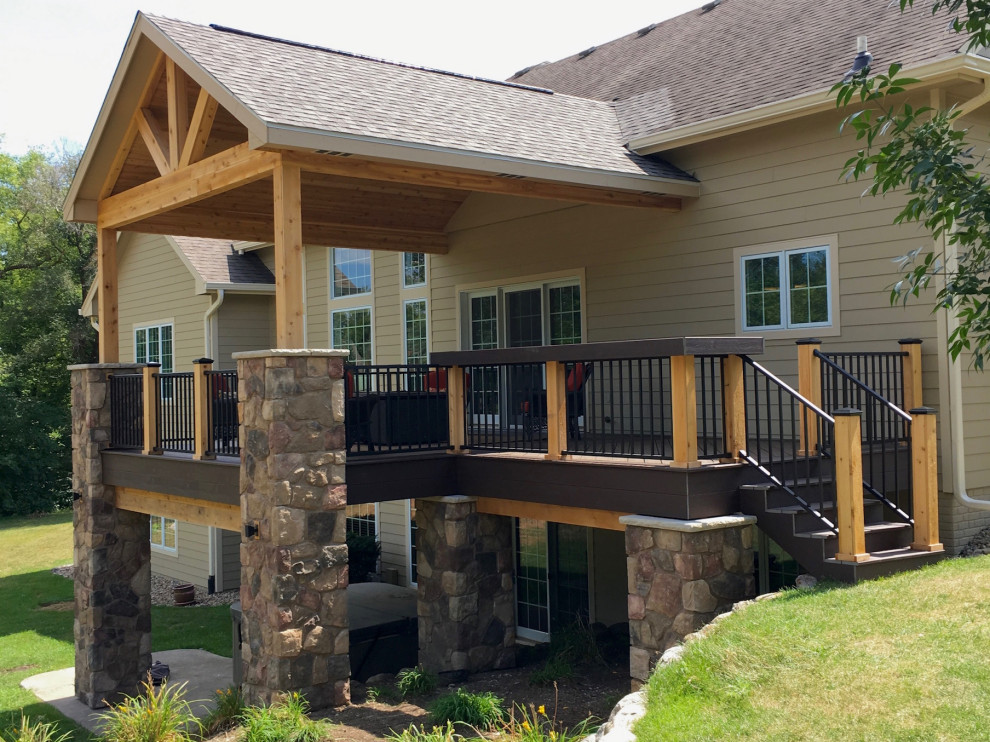 This is an example of a medium sized contemporary back veranda in Other with with columns.