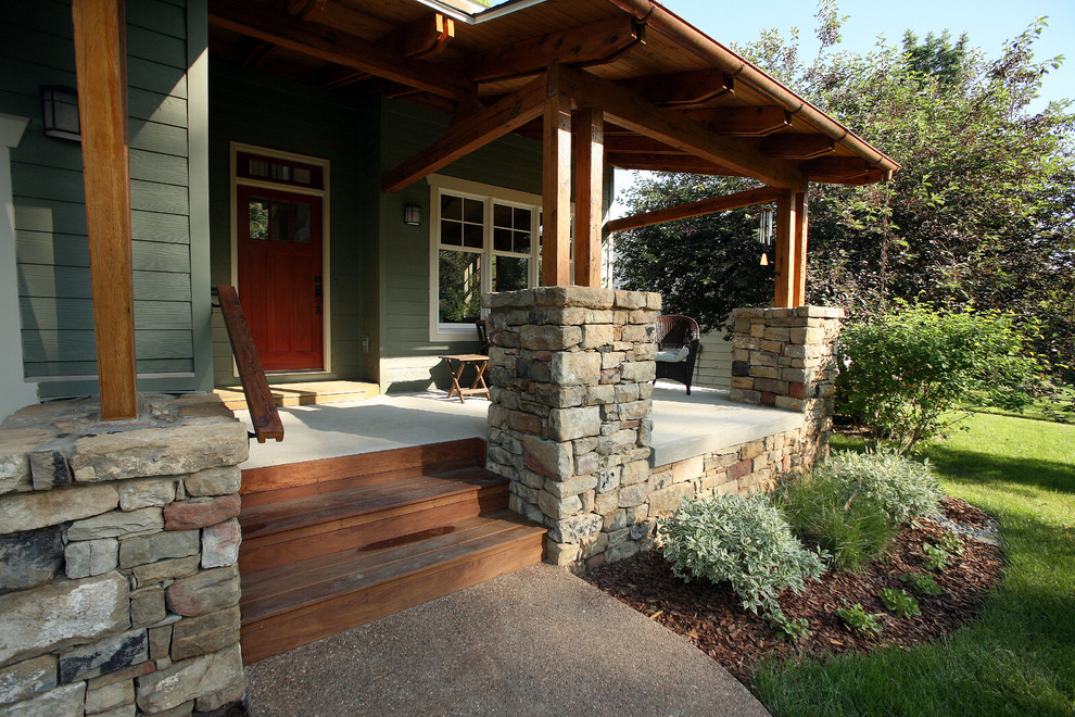 This is an example of a mid-sized craftsman front porch design in Other with a roof extension.
