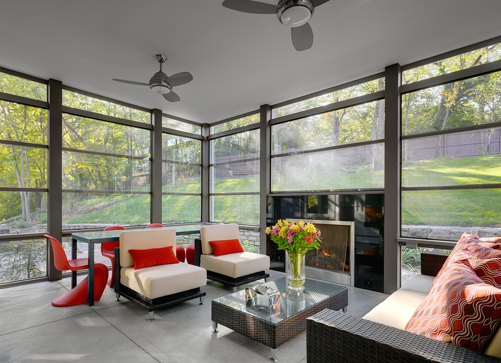 Photo of a contemporary veranda in Dallas with a fire feature, concrete slabs and a roof extension.