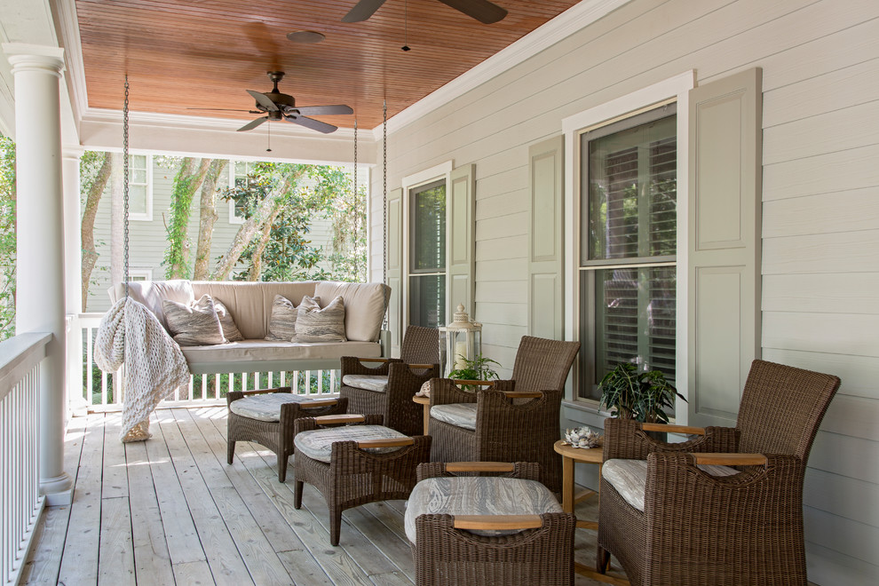 Inspiration for a large traditional front veranda in Charleston with a roof extension.