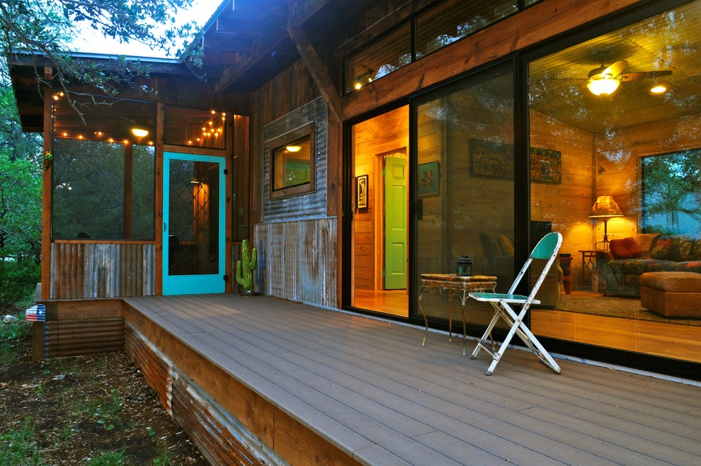 Inspiration for a rustic veranda in Austin with decking and all types of cover.