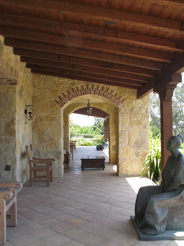 This is an example of a large farmhouse back veranda in San Diego.