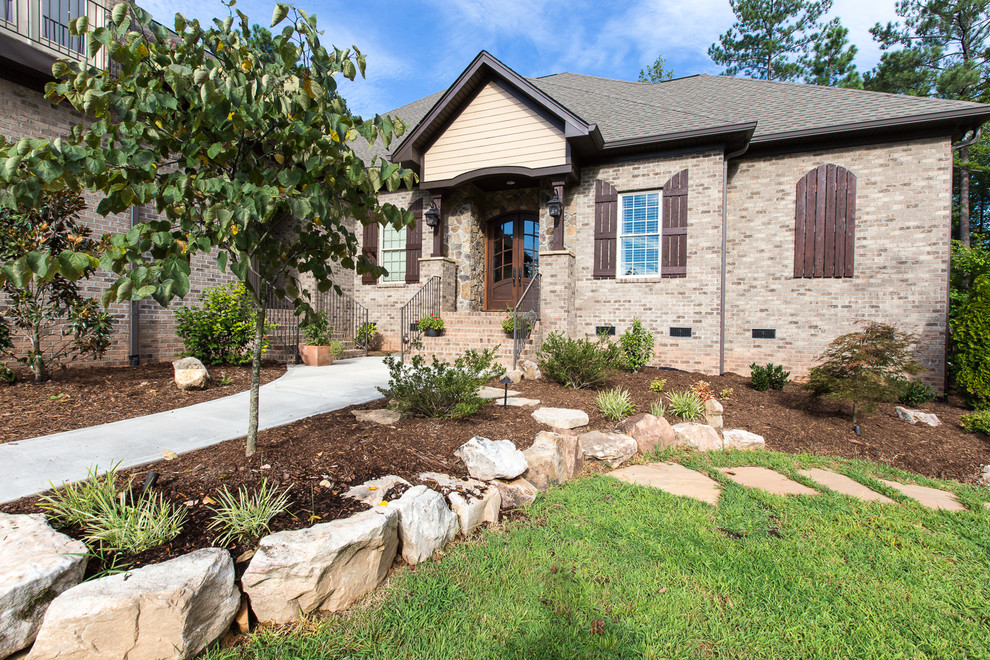 Foto di un portico american style di medie dimensioni e davanti casa con un giardino in vaso, pavimentazioni in pietra naturale e un tetto a sbalzo