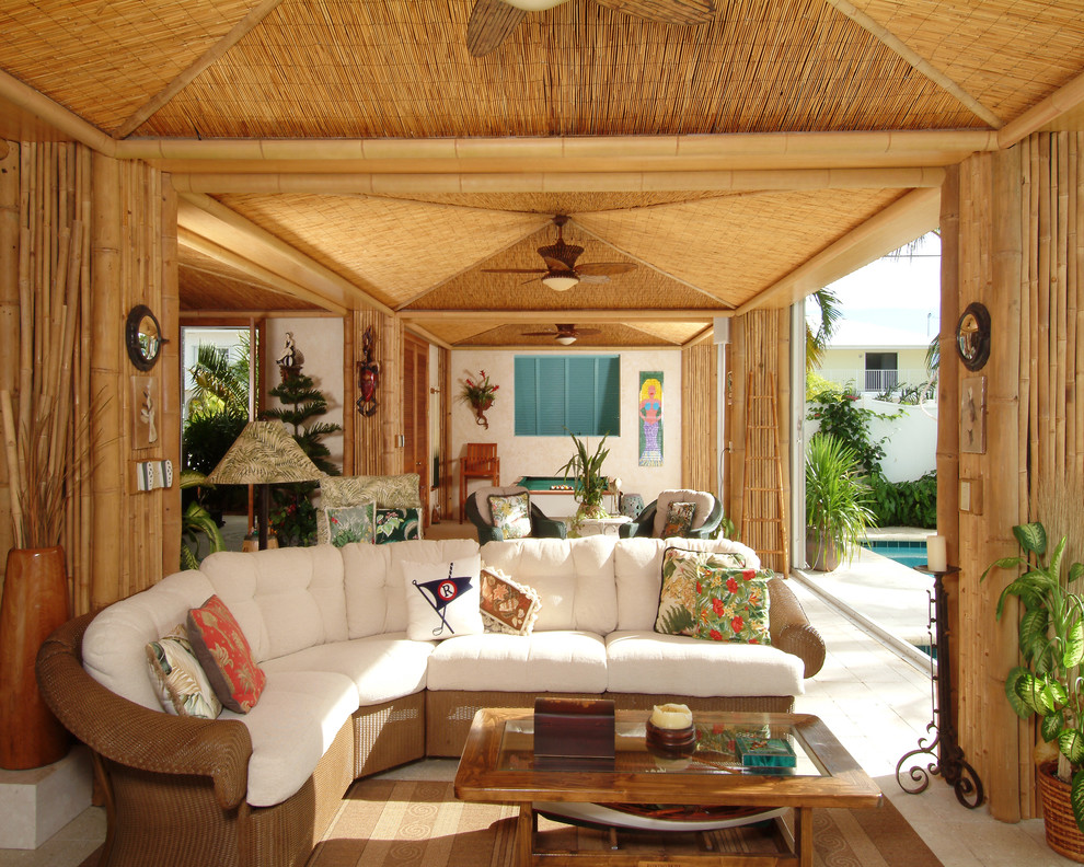 Cette photo montre un porche d'entrée de maison exotique avec une extension de toiture.