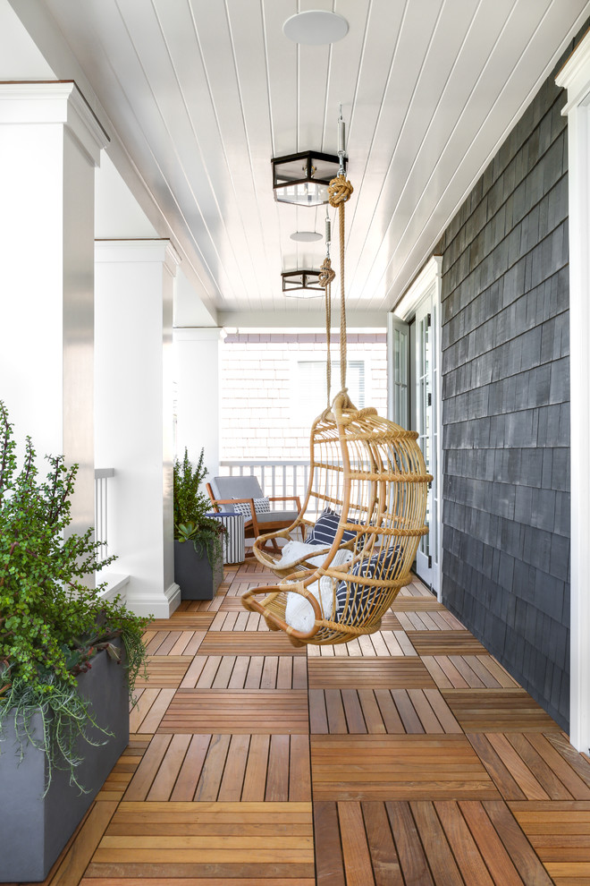 Design ideas for a beach style veranda in Los Angeles with a potted garden, decking and a roof extension.