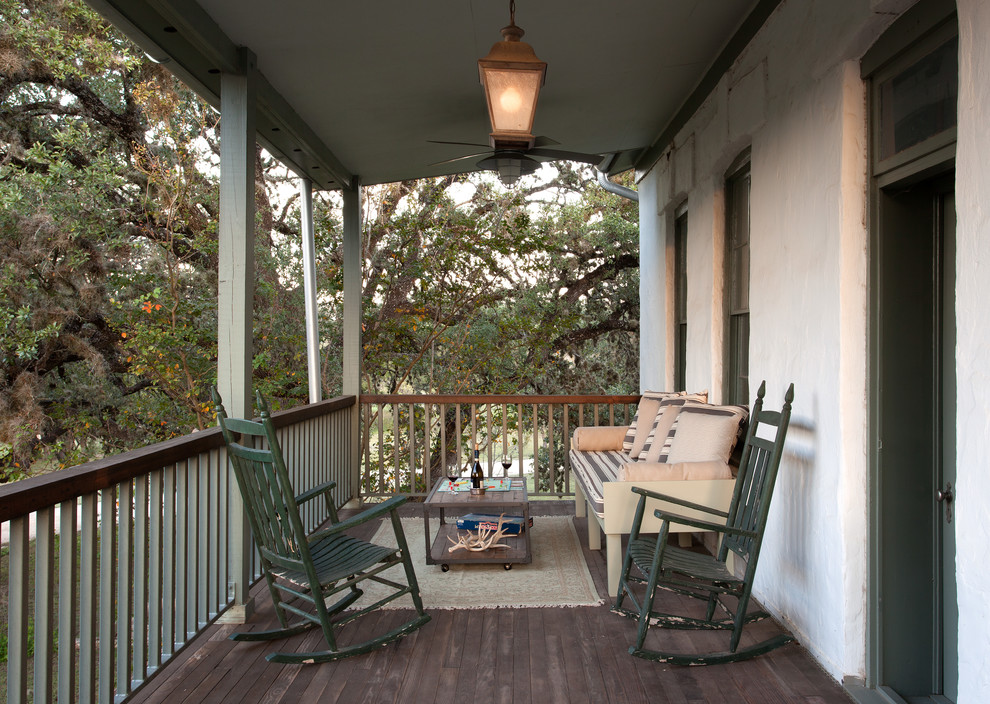 Inspiration for a mid-sized country front porch remodel in Austin with decking and a roof extension
