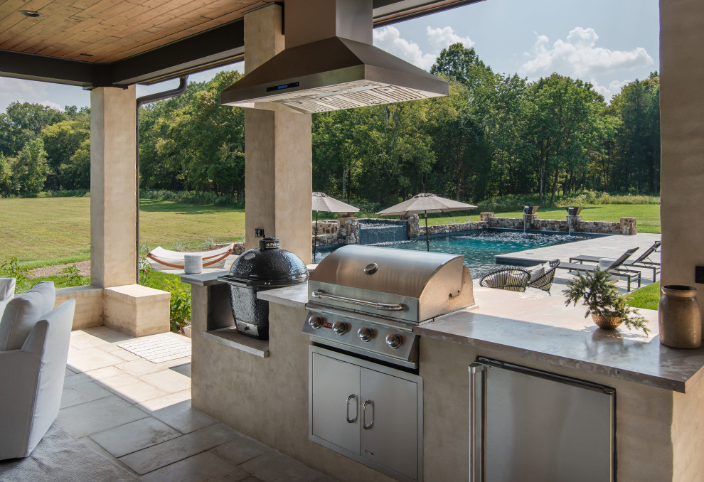 Patio kitchen - large traditional backyard patio kitchen idea in Nashville with a roof extension
