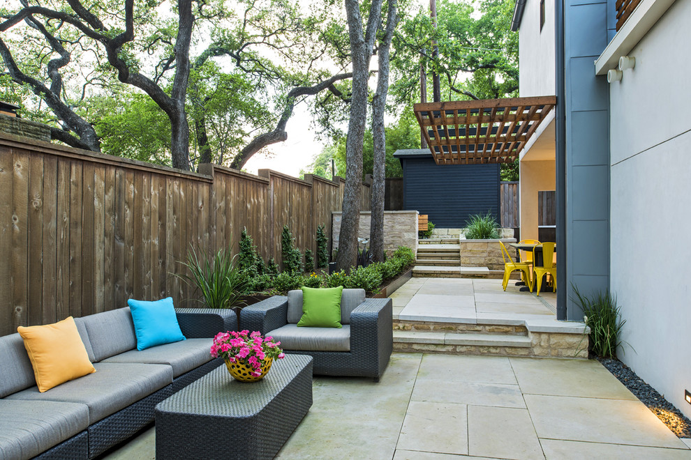 Medium sized contemporary back patio in Austin with concrete slabs.