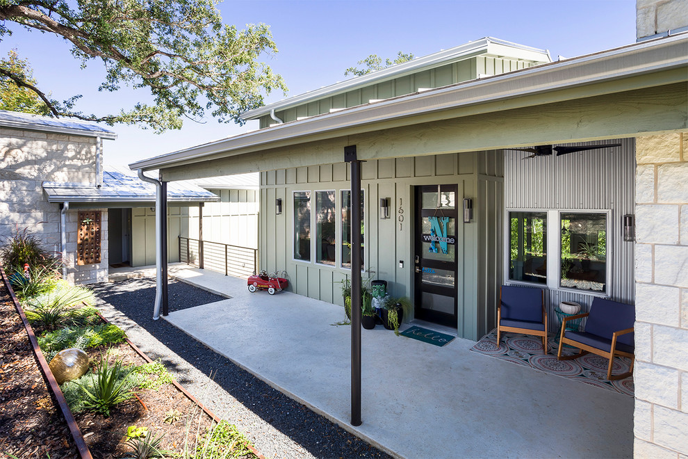 Mid-sized farmhouse concrete porch photo in Austin with a roof extension