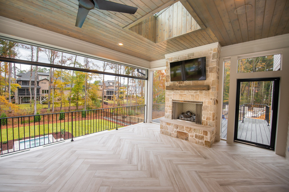 Inspiration for a contemporary back screened veranda in Raleigh with tiled flooring and a roof extension.