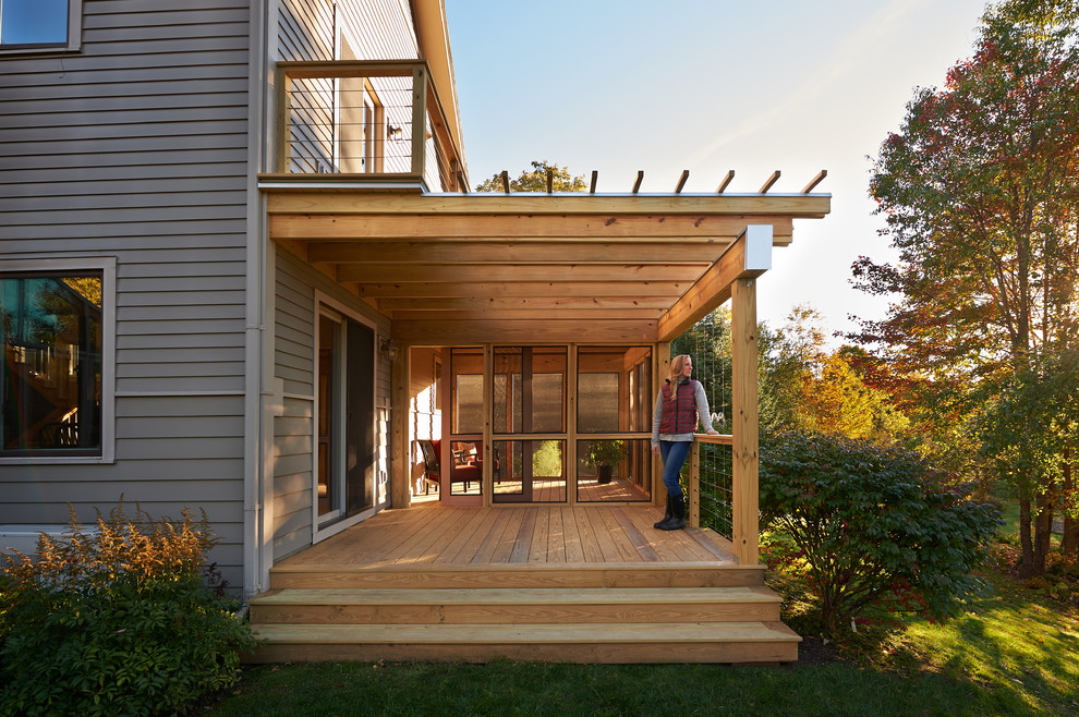 Inspiration pour un porche d'entrée de maison latéral minimaliste de taille moyenne avec une moustiquaire et une pergola.