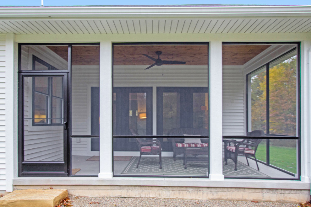 Idéer för en mellanstor innätad veranda på baksidan av huset, med betongplatta och takförlängning