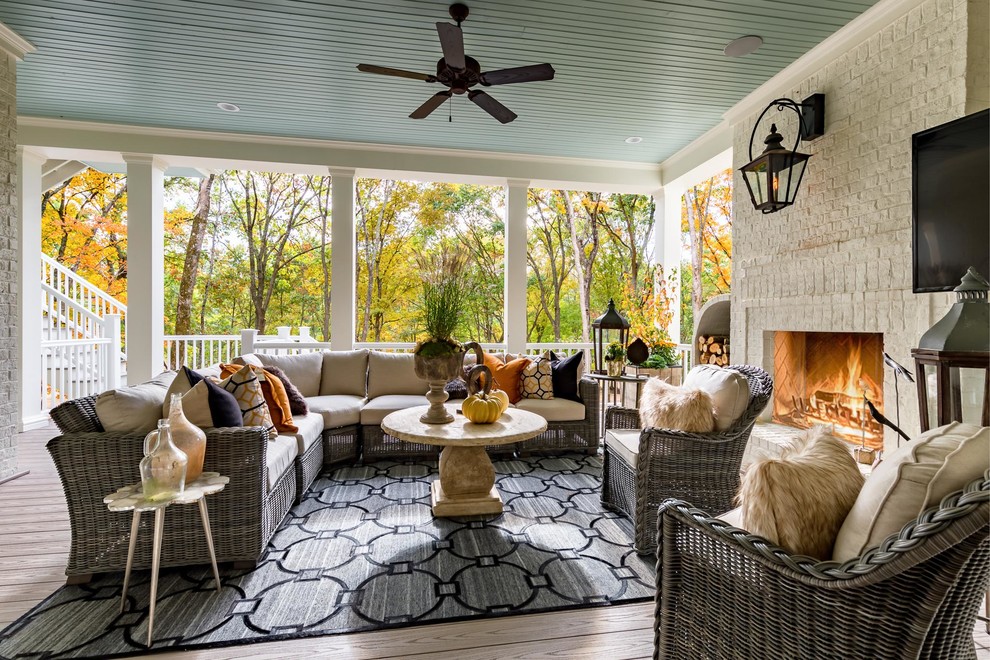 Large classic back porch idea in Nashville with a fire pit, decking and a roof extension