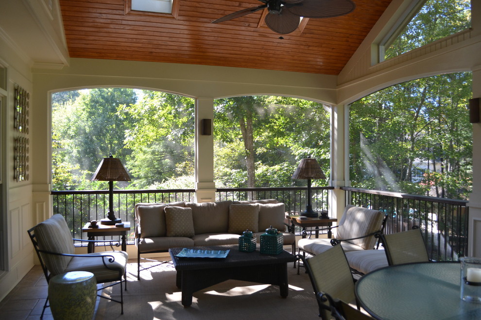 Inspiration for a large classic back veranda in Raleigh with tiled flooring, a roof extension and feature lighting.