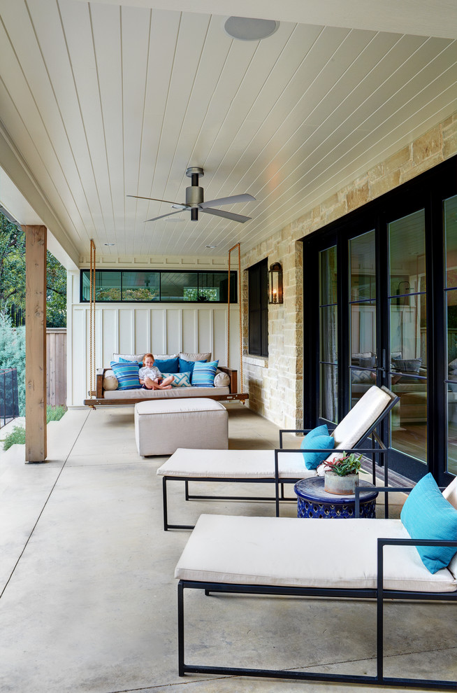 Inspiration for a large rural side veranda in Austin with concrete slabs and a roof extension.